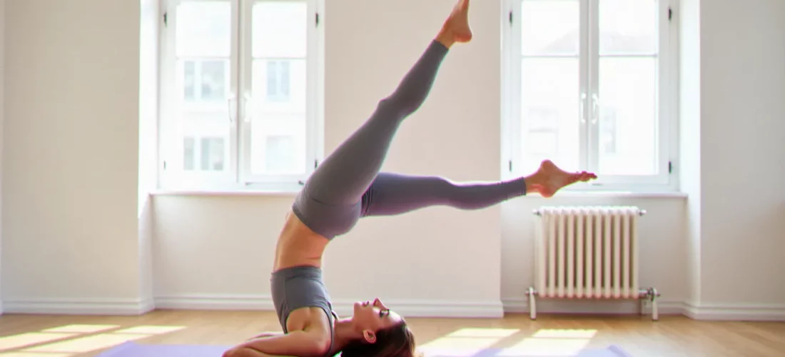 Femme réalisant la posture de la chandelle en yoga (Sarvangasana) sur un tapis violet dans un studio lumineux, illustrant yoga comment faire la chandelle